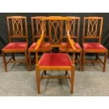 A set of five inlaid mahogany dining chairs, shaped backs, red upholstered seats, boxwood stringing,