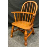 A 19th century style child's oak and elm windsor chair, 62cm tall (26cm height to seat).