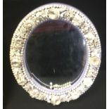 A Sampson Hancock Derby oval mirror, encrusted with chrysanthemums and other foliage, 32cm high, c.
