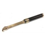 An early 20th century gold coloured metal mounted propelling pencil