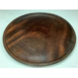 A 19th century mahogany circular tray or waiter, 30cm diam
