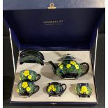 A contemporary Moorcroft tea for two, Buttercup, tube lined with bright flowerheads, boxed