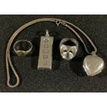 A hallmarked silver ingot; a heart locket; two rings