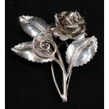 A silver brooch, as a rose, 8cm long, marked Sterling