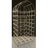 An iron floor standing wine rack, to hold twenty five bottles, 98cm high