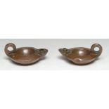A pair of Arts and Crafts copper lamps, after the Antique in the Grand Tour taste, 16.5cm long,