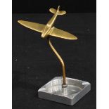 Aeronautica - an Art Deco design alloy desk ashtray, surmounted by a brass model of a WWII Spiitfire