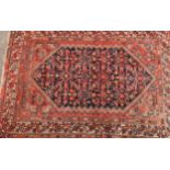 A 19th century Turkish carpet, the hexagonal field filled with stylised flowerheads and motifs, on a