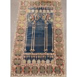 A 19th century Persian carpet, with triple Mihrab, 215cm x 122cm