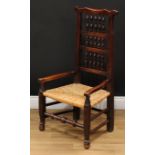 A 19th century rush seated spindle-back elbow chair, turned front stretcher, 96cm high, 52cm wide,