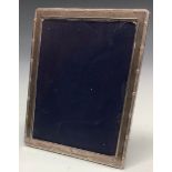 An Elizabeth II silver rounded rectangular easel photograph frame, the aperture 19.5cm x 14.5cm,