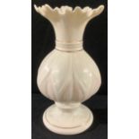 A Belleek frill neck baluster vase, tones of pink with gilt banding, 20.5cm high