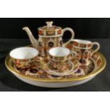 A Royal Crown Derby 1128 Imari pattern miniature tea set, comprising teapot, cream jug, sugar