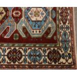 A Middle Eastern woollen rug, the rectangular filled with three large octagonal gulls, in green,
