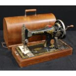 A Singer hand cranked sewing machine, cased