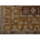 A Middle Eastern rug, central rectangular light brown field filled with five stylised gulls,