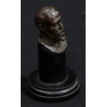 An early 20th century brown patinated bronze desk bust, King Edward VII, ebonised plinth, 14cm high