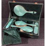 A George VI silver and enamel five piece dressing table set, London 1938, cased
