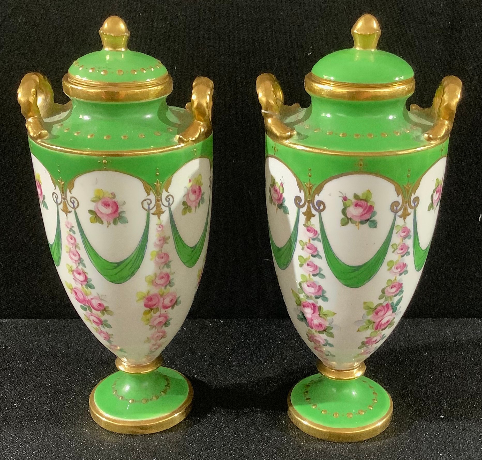 A pair of miniature Minton pedestal two handled vases and covers, printed and painted with