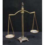 A set of 19th century style balance scales, reeded Corinthian column with lion finial, flanked by