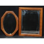 An oak framed rectangular wall mirror, bevelled plate, 68.5cm x 84cm overall; another, octagonal,