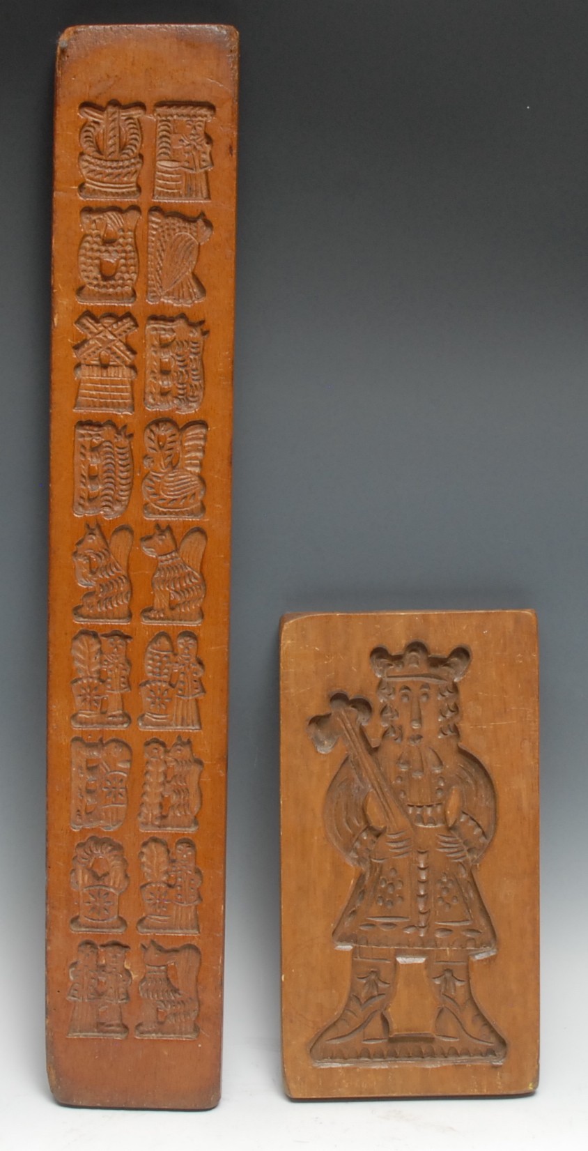 Treen - a Continental beech biscuit mould, intaglio carved with figures and animals, 69.5cm long;