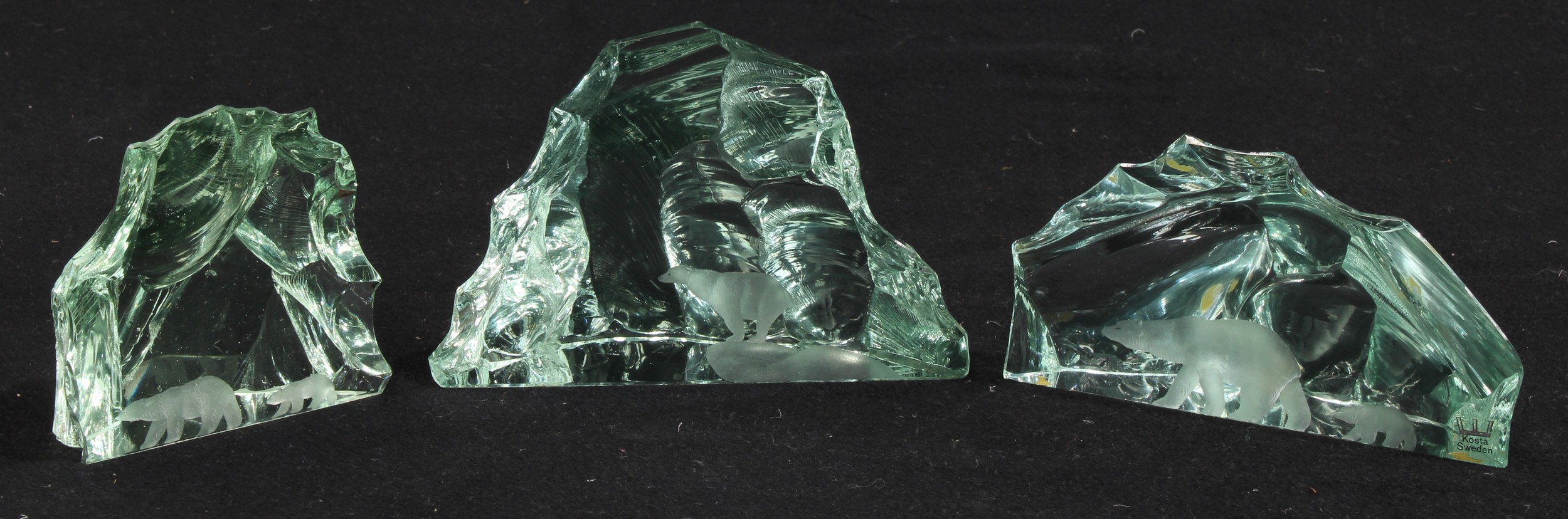 A suite of three Kosta Boda 'iceberg' etched glass sculptures, each intaglio cut with Polar bears,