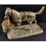 A Victorian cast metal pin cushion modelled as a dog with basket, kite mark to maquette, 15cm long