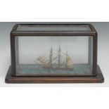 An early 20th century folk art maritime model, of a sailing ship on a choppy sea, rectangular glazed