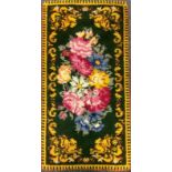 A mid 20th century English wool rug, with bright flowers on a green ground, 173cm x 91cm, c.1940