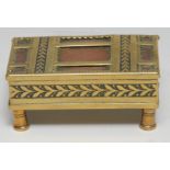 An early 20th century brass three-section stamp box, hinged cover with match striker, 8cm wide