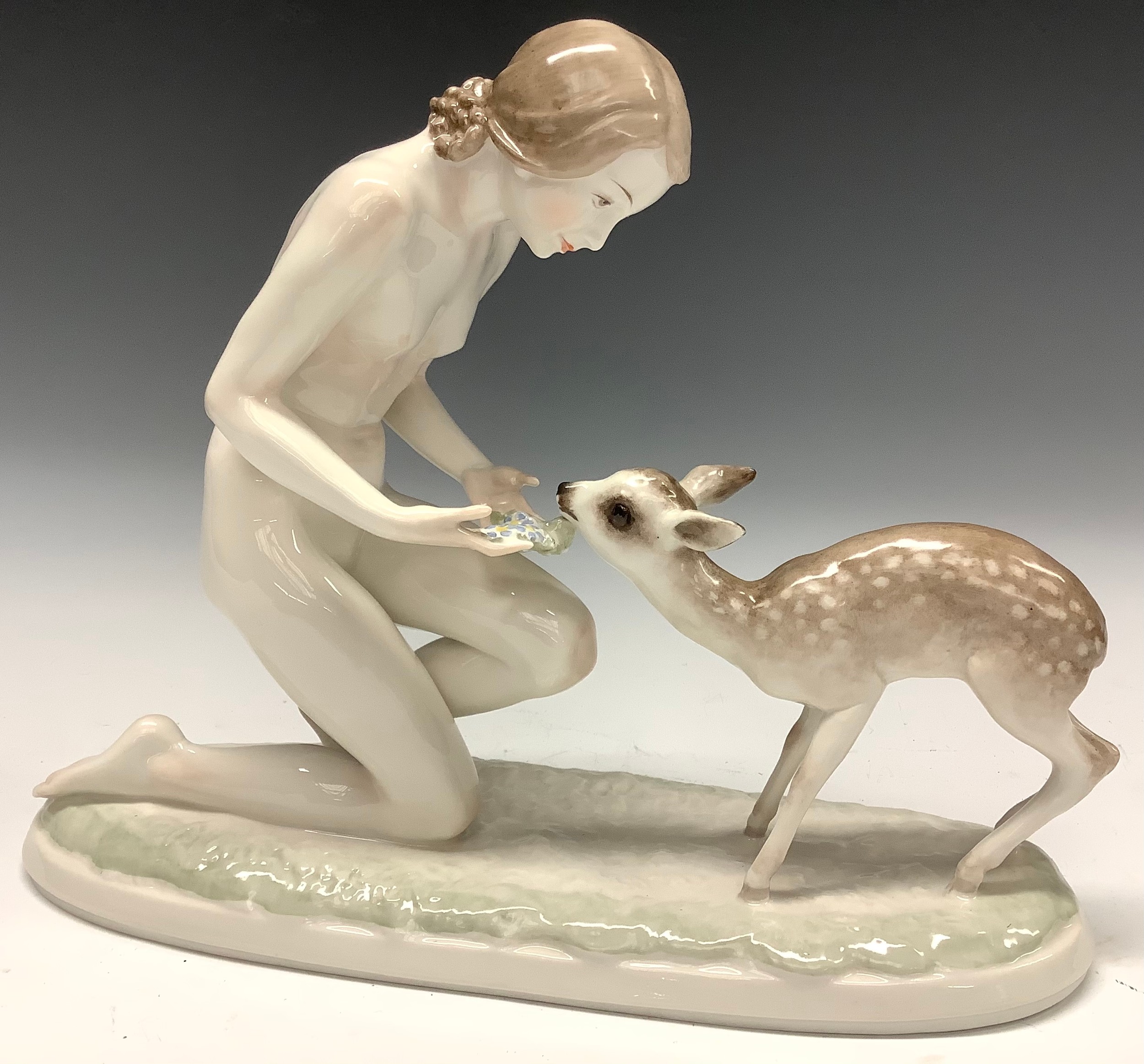A Hutschenreuther figure, Gute Freunde, female nude with fawn, modelled by Carl Werner, 32cm wide,