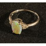 An 18k white gold opal ring, the shoulders accented with diamonds, ring size R, 3.78g