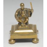 A post-Regency gilt brass desk weight, cast in the Chinioserie taste with a Chinese figure,