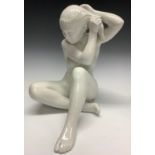 A Bing and Grondahl figure, female nude arranging her hair, white gloss glaze, number 2280, 24cm,