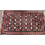 A Middle Eastern woollen rug, with geometrical guls, in tones of brown and orange, 156cm x 83cm