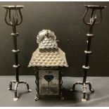 A pair of wrought iron pricket style candle stands, 55cm high; a hall lantern, with stained glass