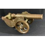 An early 20th century bronze model cannon, 22cm long