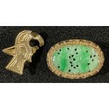 A Chinese Jadite and silver gilt oval brooch, carved and pierced with flowering foliage, wirework