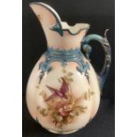 A Hadley's Worcester Faience lobed ovoid jug, painted in sepia tones with a bird perched amongst