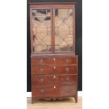 A George III mahogany library bookcase, outswept cornice above a pair of astragal glazed doors,