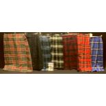 A Scottish woolen tartan kilt; others, various tartans, with a book of patterns