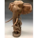 A carved hardwood African elephant family group, mother with three entwined calves, 63cm high (
