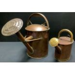 A large Victorian copper watering can, 45cm high, c.1880; another, smaller 30cm high (2)