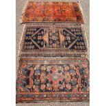 A hand woven geometric carpet, in shades of blue and red with tassels, 92cm wide; another smaller