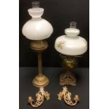 A late 19th century Art Nouveau style oil lamp, pierced cast iron base, opaque shade printed with