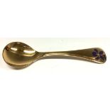 Georg Jensen - a Danish silver-gilt and enamel spoon