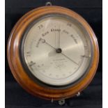 A late 19th century barometer, silvered dial, M Pillischer, London, oak mount, 30cm diam