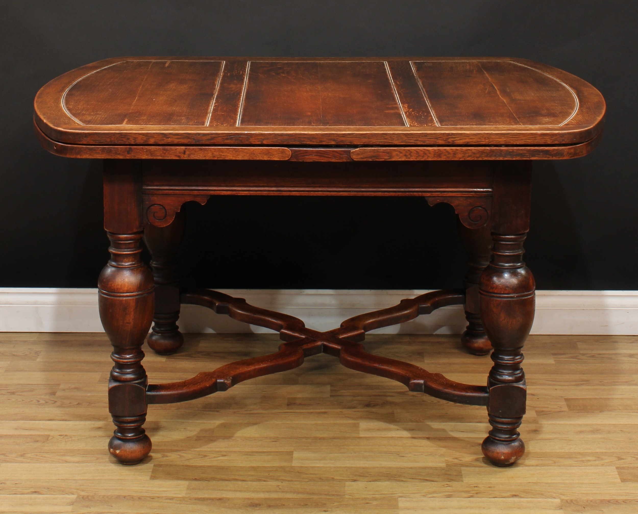 An early 20th century oak draw-leaf dining table, 76cm high, 129cm opening to 213cm long, 99cm wide - Image 2 of 3