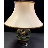 A Moorcroft Western Isles pattern compressed ovoid table lamp, wooden base, shade, 43cm overall